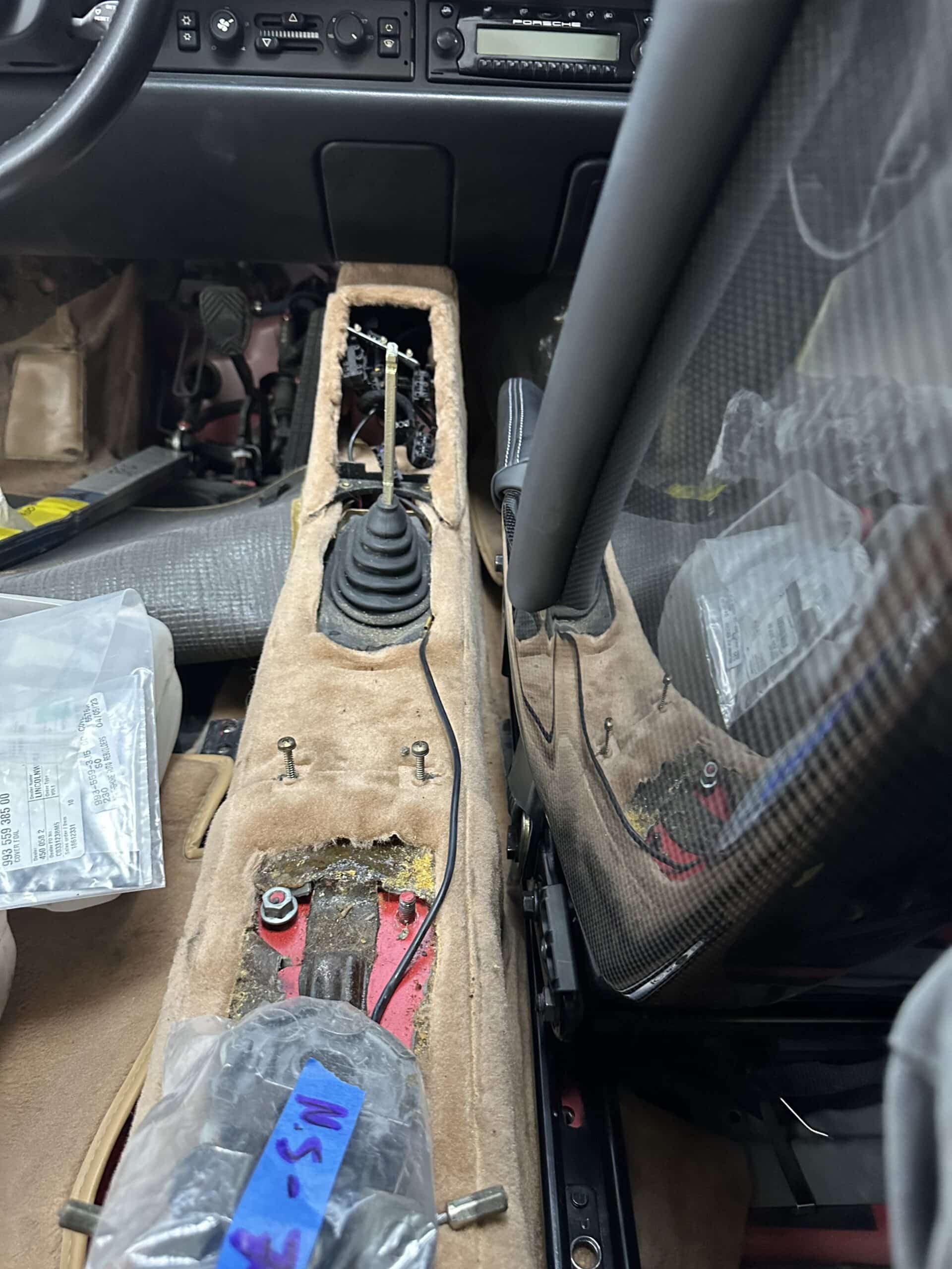 Inside a car with a predominance of plastic materials, highlighting the dashboard, seats, and interior trim.