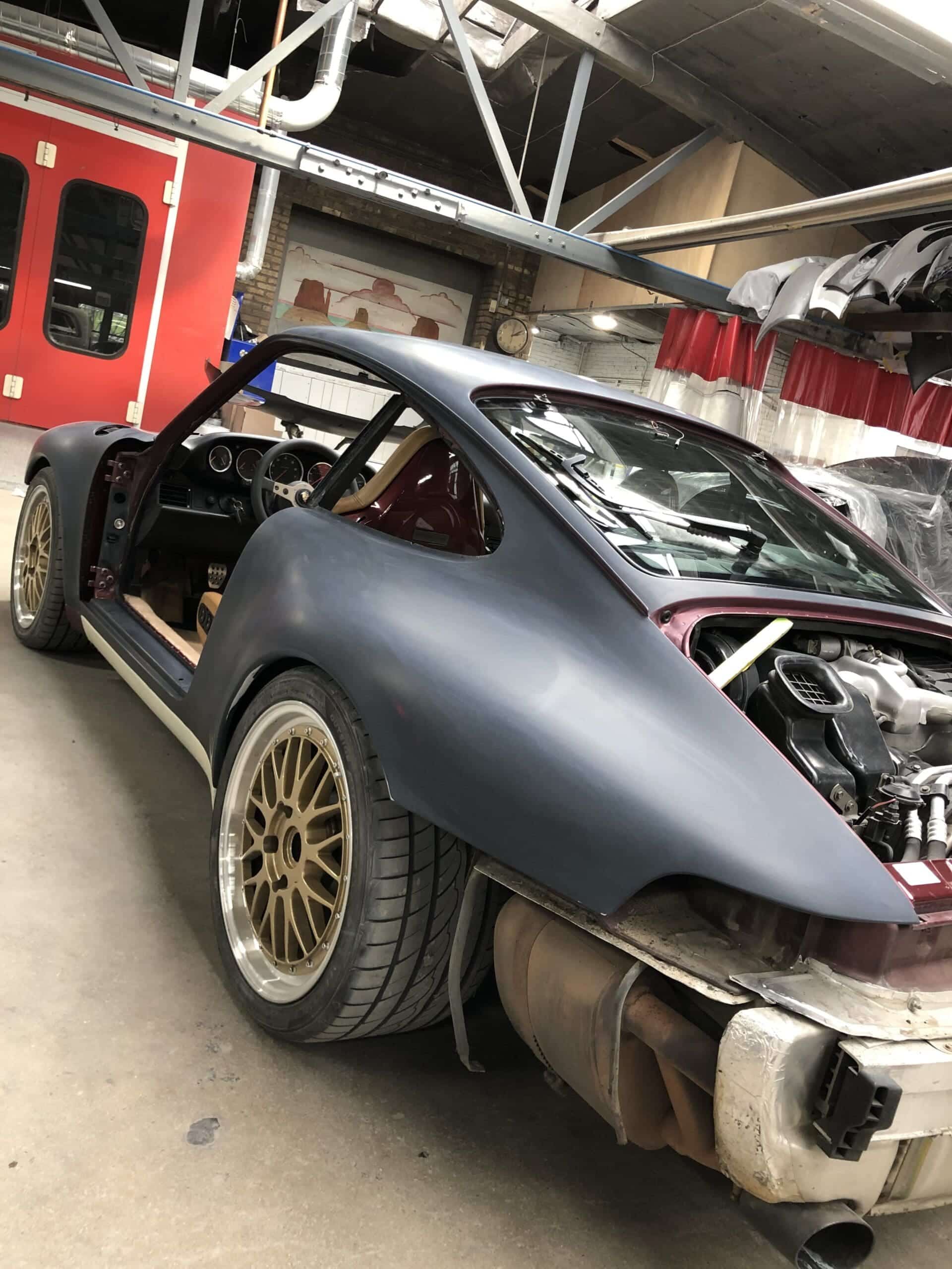 A sleek Porsche 911 Carrera featuring a powerful turbo engine and a prominent turbocharger under the hood.