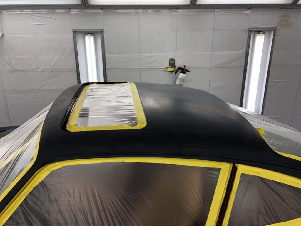 A car painted in bright yellow and black, showcasing a striking two-tone design.