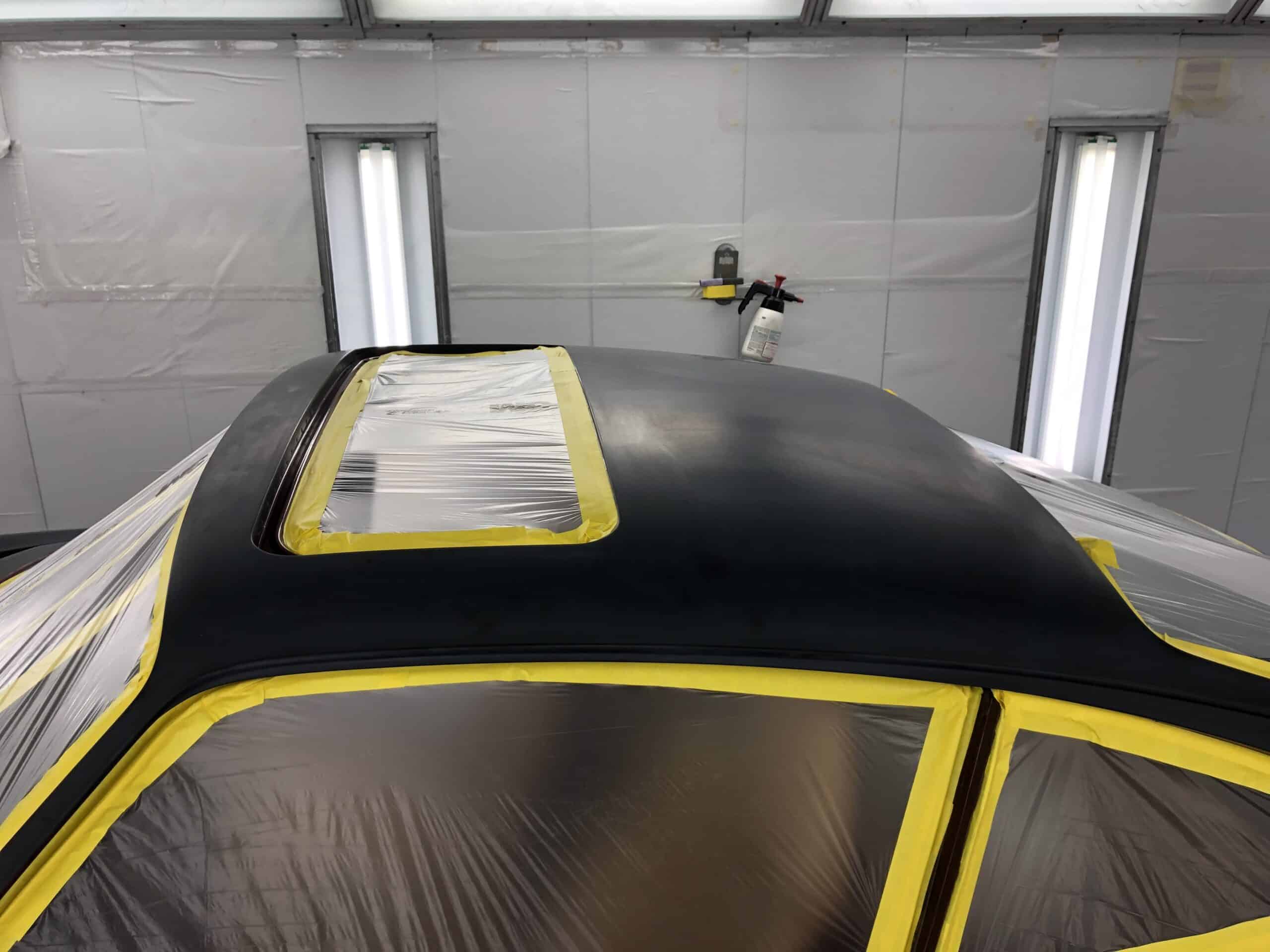 A car painted in bright yellow and black, showcasing a striking two-tone design.