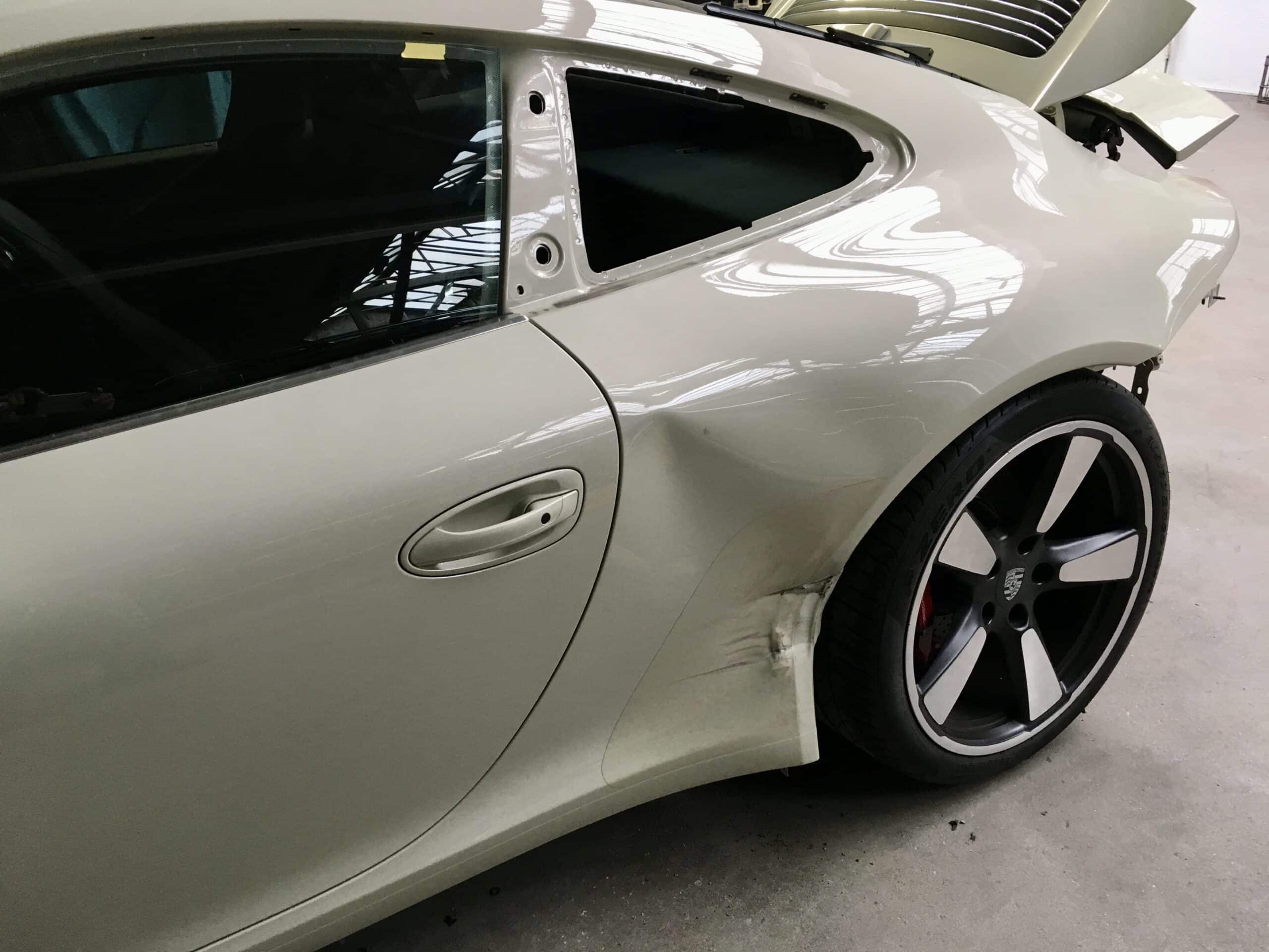 Driver's side fender of a stylish car with scratches and dents
