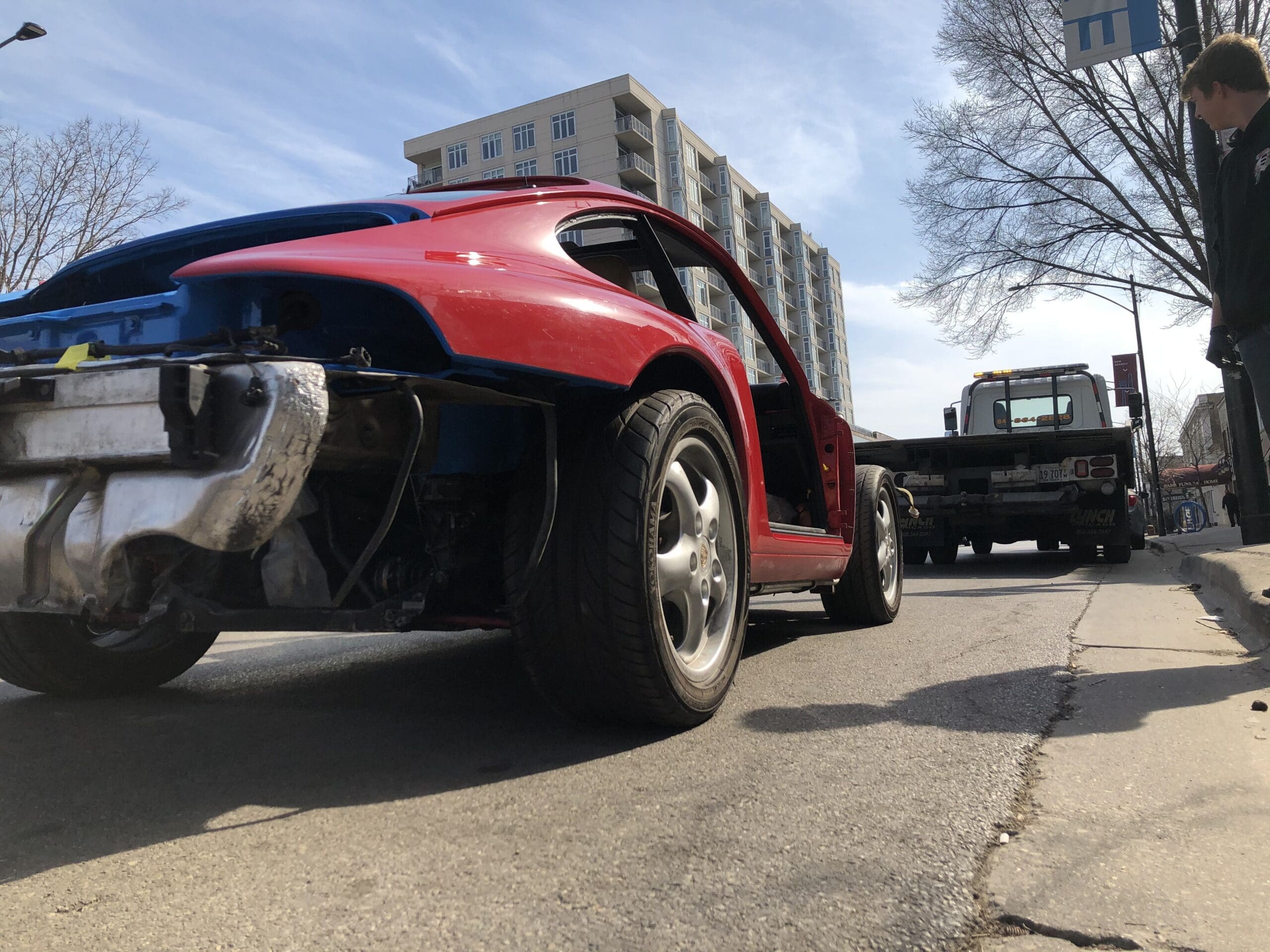 A red and blue car parked on a street, showcasing its vibrant colors and sleek design.