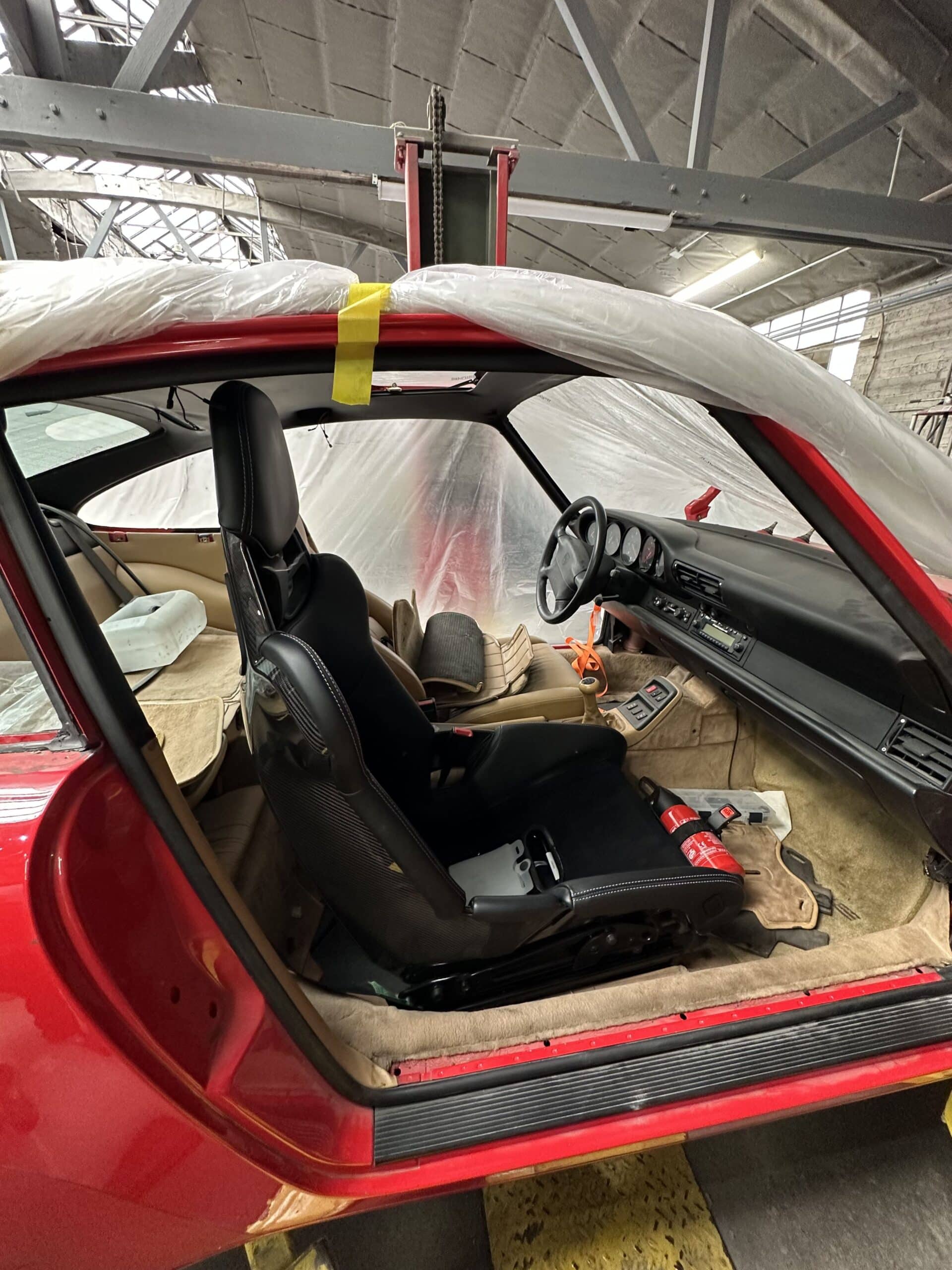 Interior view of a car featuring extensive plastic surfaces and components throughout the dashboard and seating area.